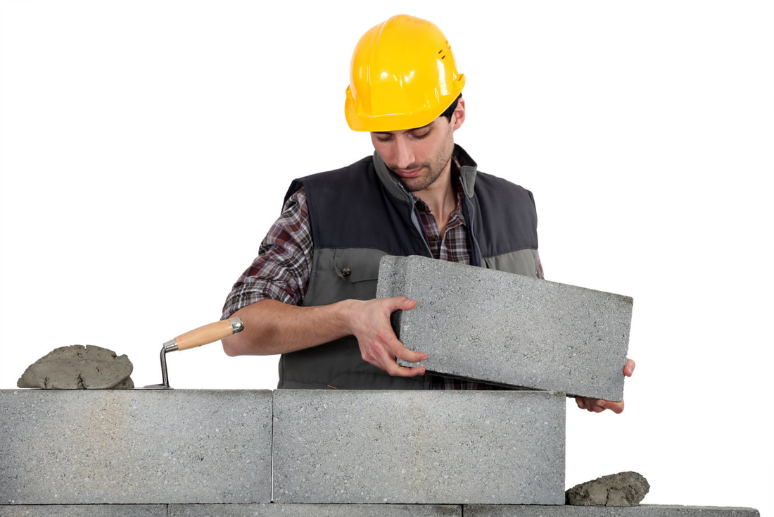 contractor instaling block wall
